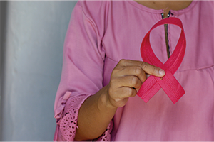 ‘Exhausted’ immune cells in healthy women could be target for breast cancer prevention Woman holds pink breast cancer awareness ribbon. Credit angiola-harry-unsplash